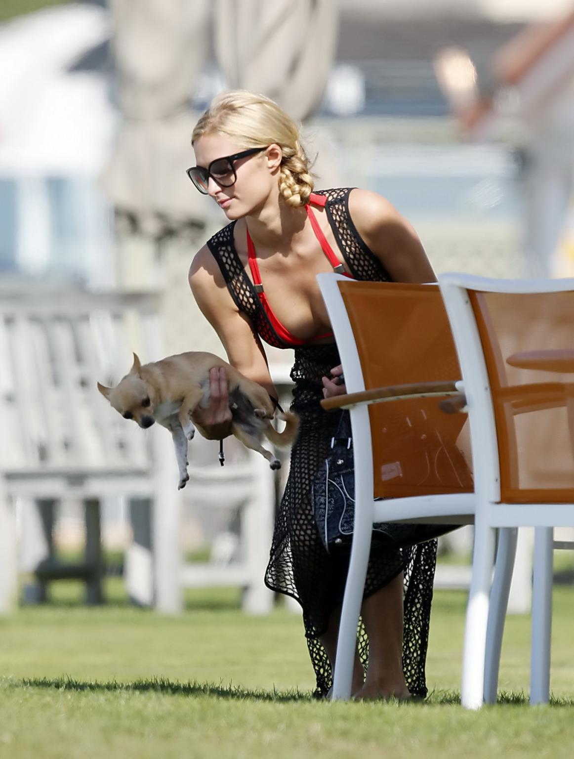 16P Paris Hilton wearing tiny red bikini and fishnet dress at the beach in Malibu