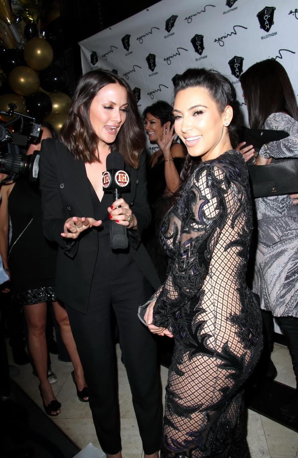 10P Kim Kardashian in black fishnet dress hosting the New Year's Eve Countdown in La