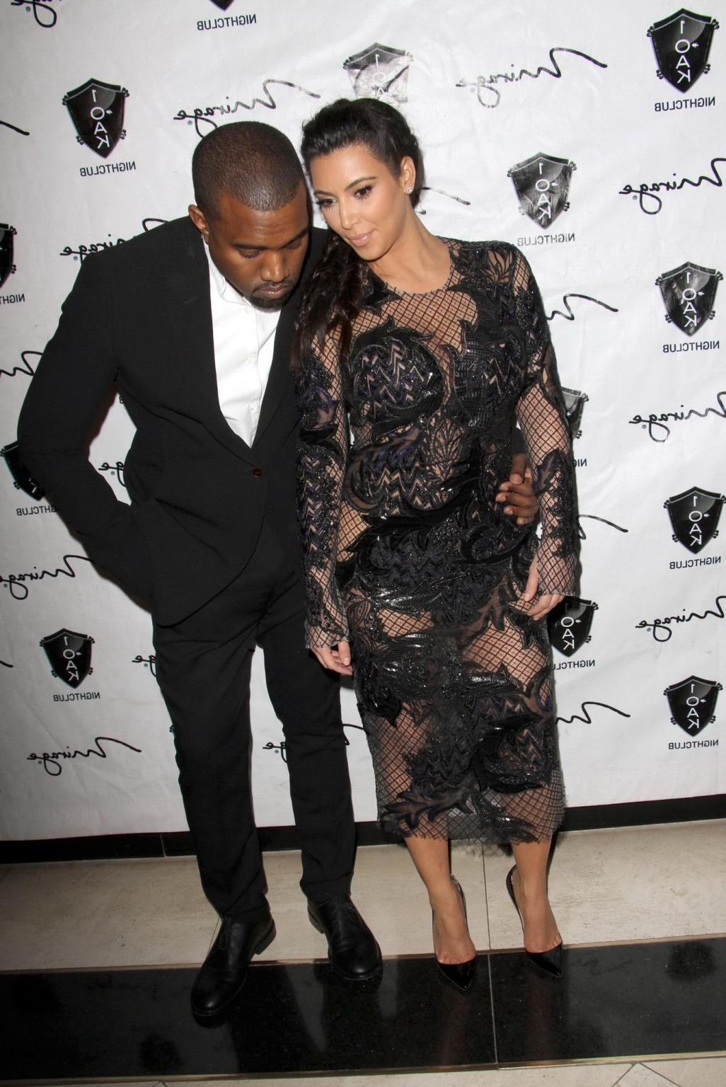 10P Kim Kardashian in black fishnet dress hosting the New Year's Eve Countdown in La