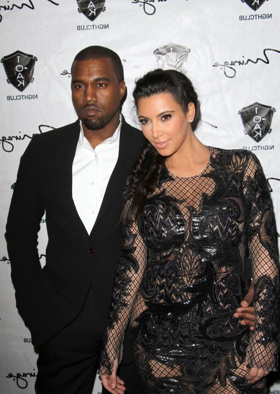 10P Kim Kardashian in black fishnet dress hosting the New Year's Eve Countdown in La