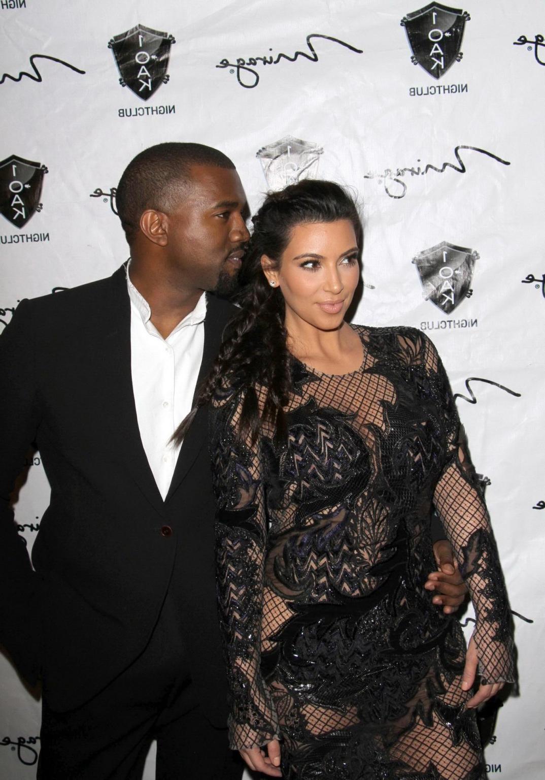 10P Kim Kardashian in black fishnet dress hosting the New Year's Eve Countdown in La