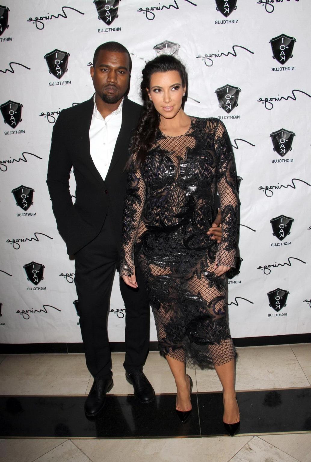 10P Kim Kardashian in black fishnet dress hosting the New Year's Eve Countdown in La