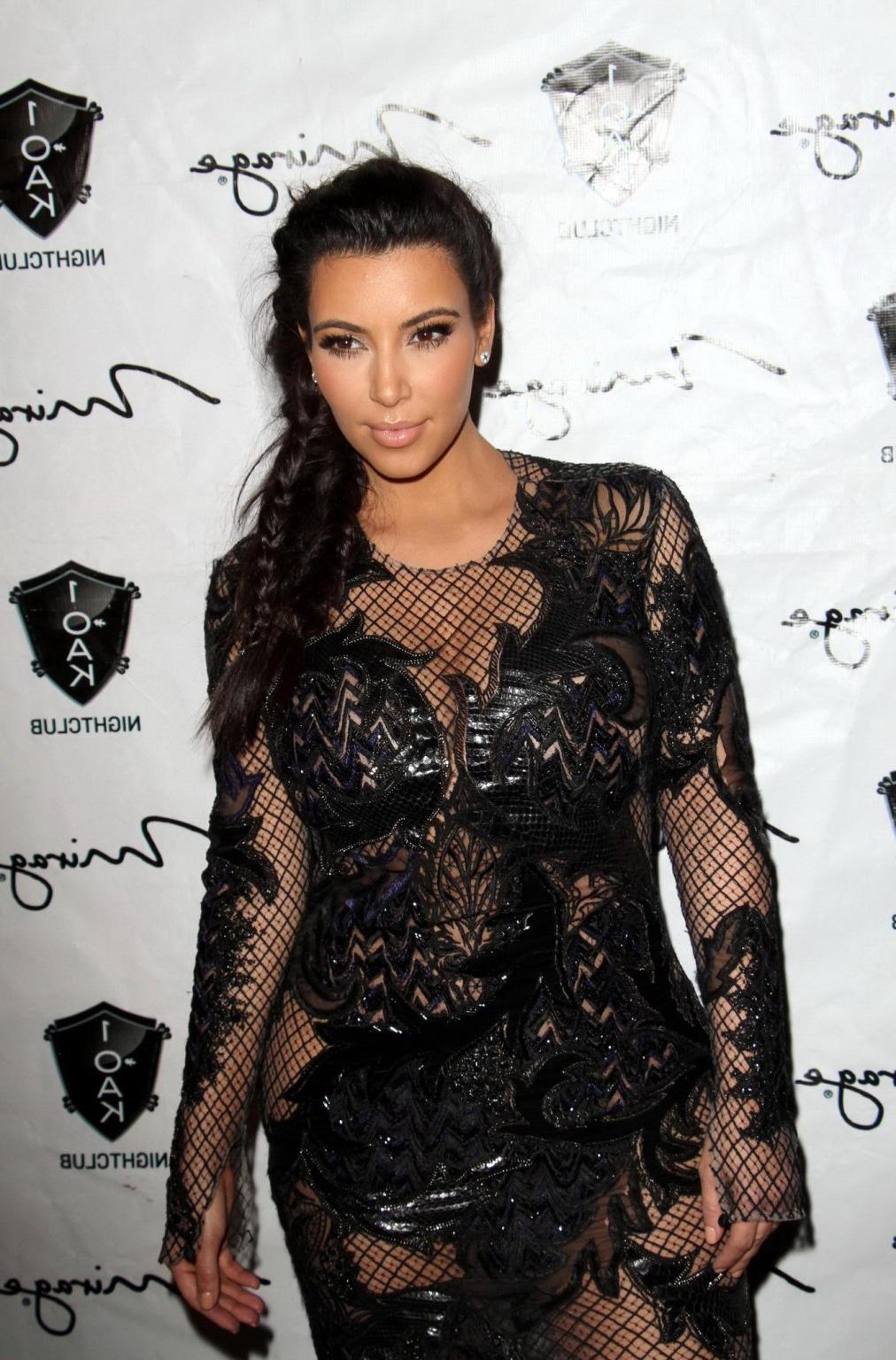 10P Kim Kardashian in black fishnet dress hosting the New Year's Eve Countdown in La