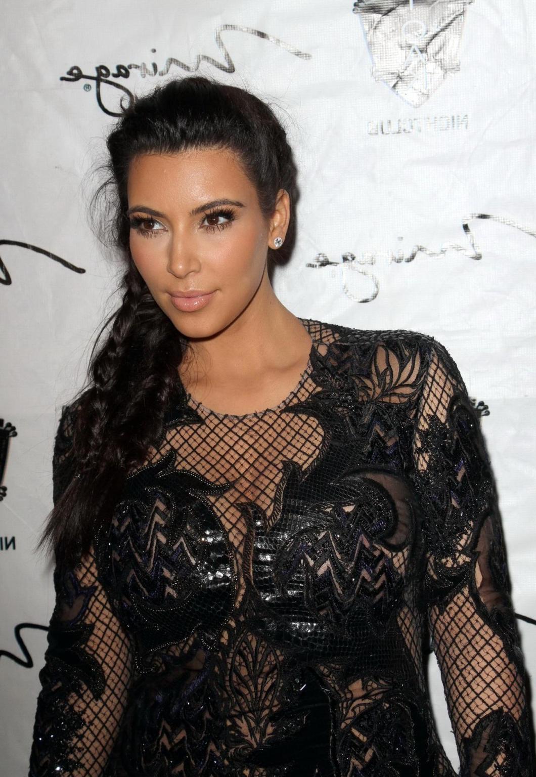 10P Kim Kardashian in black fishnet dress hosting the New Year's Eve Countdown in La
