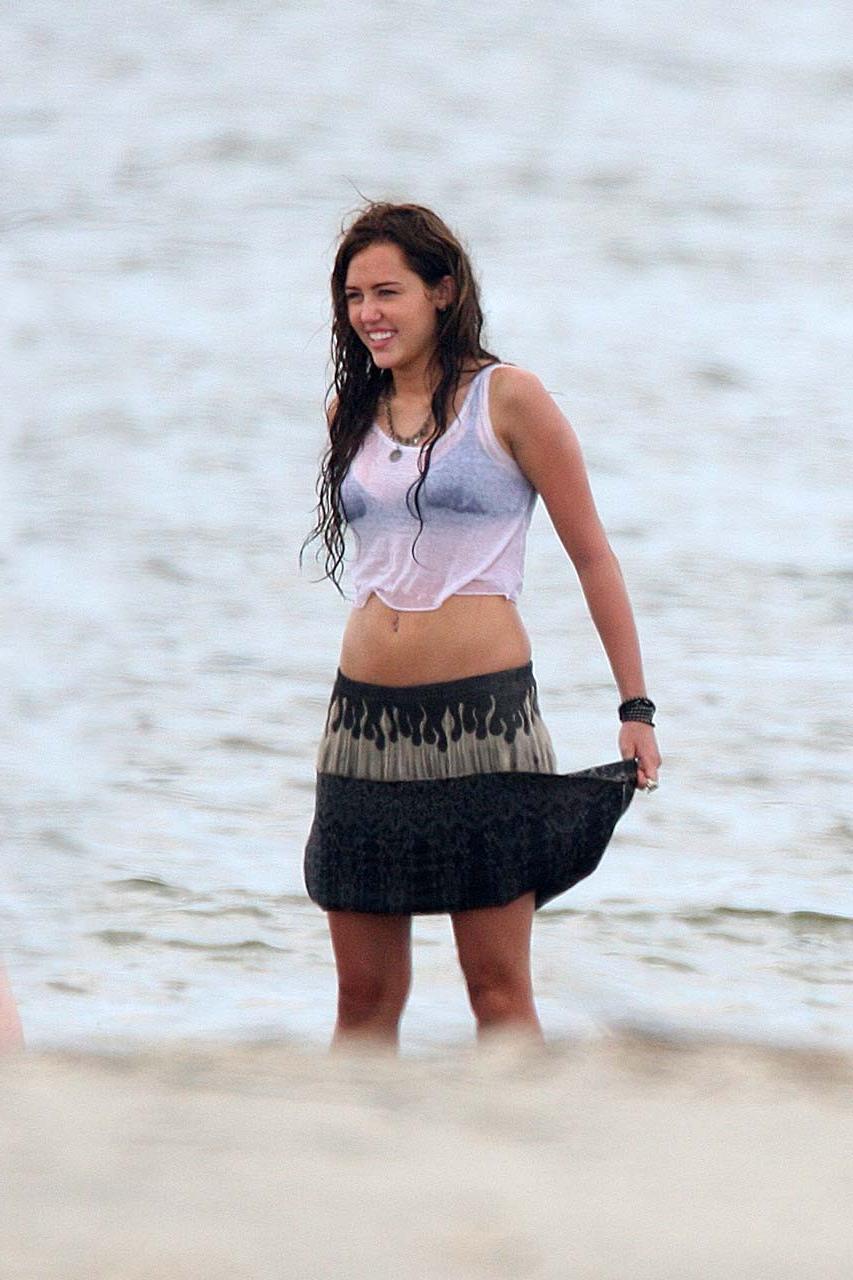 16P Miley Cyrus exposing her sexy body and nice boobs in wet clothes
