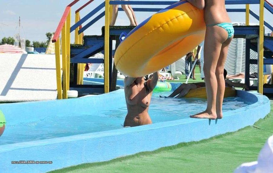 15P Sexy Latina bares her tits in the pool