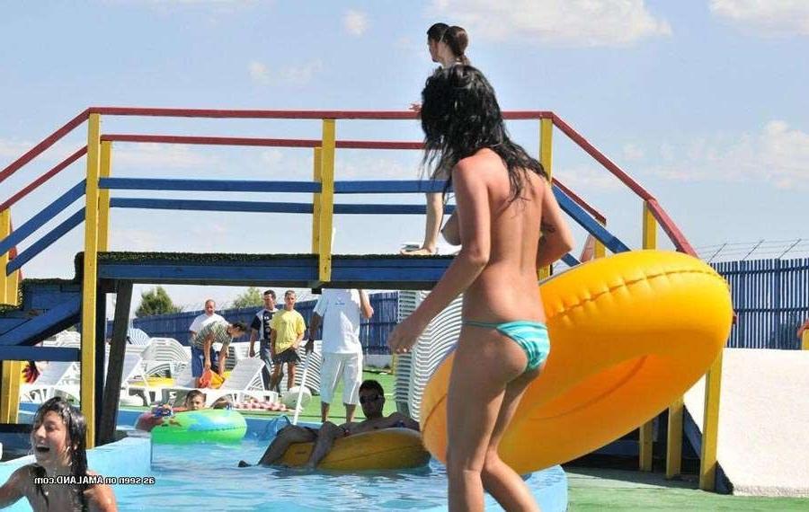 15P Sexy Latina bares her tits in the pool
