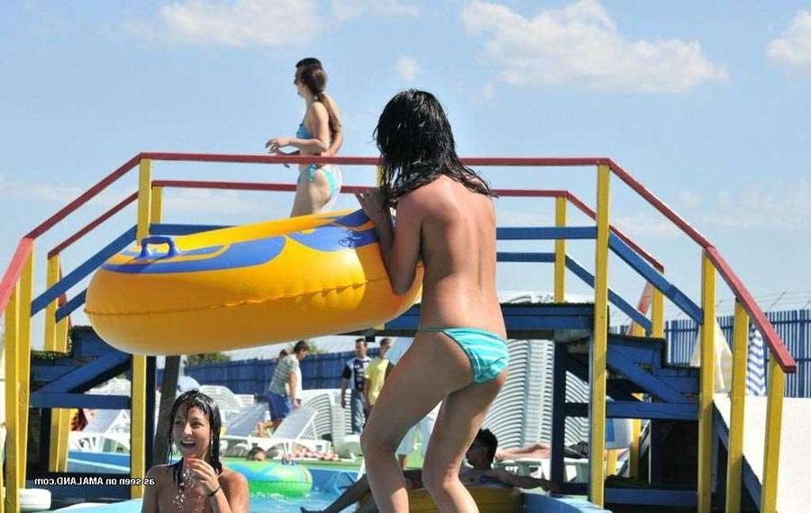 15P Sexy Latina bares her tits in the pool