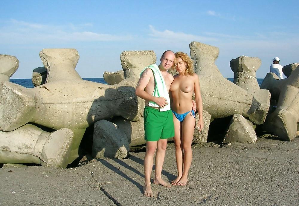 20P Young girl topless at the beach.