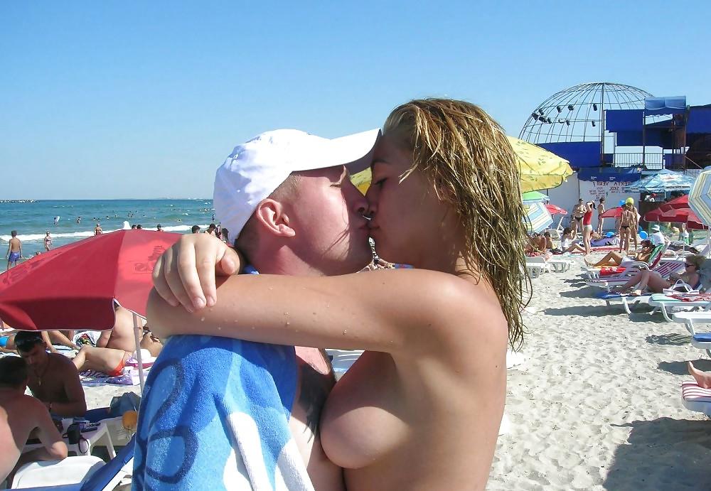 20P Young girl topless at the beach.