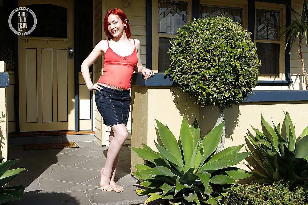 15P Beautiful redhead spreads her hairy pussy outdoors