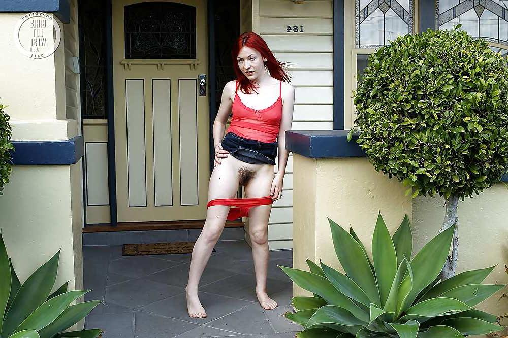 15P Beautiful redhead spreads her hairy pussy outdoors