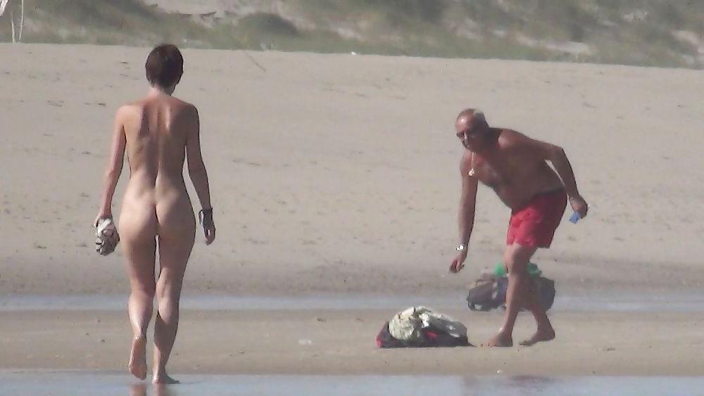 13P Nude girl walking on european beach