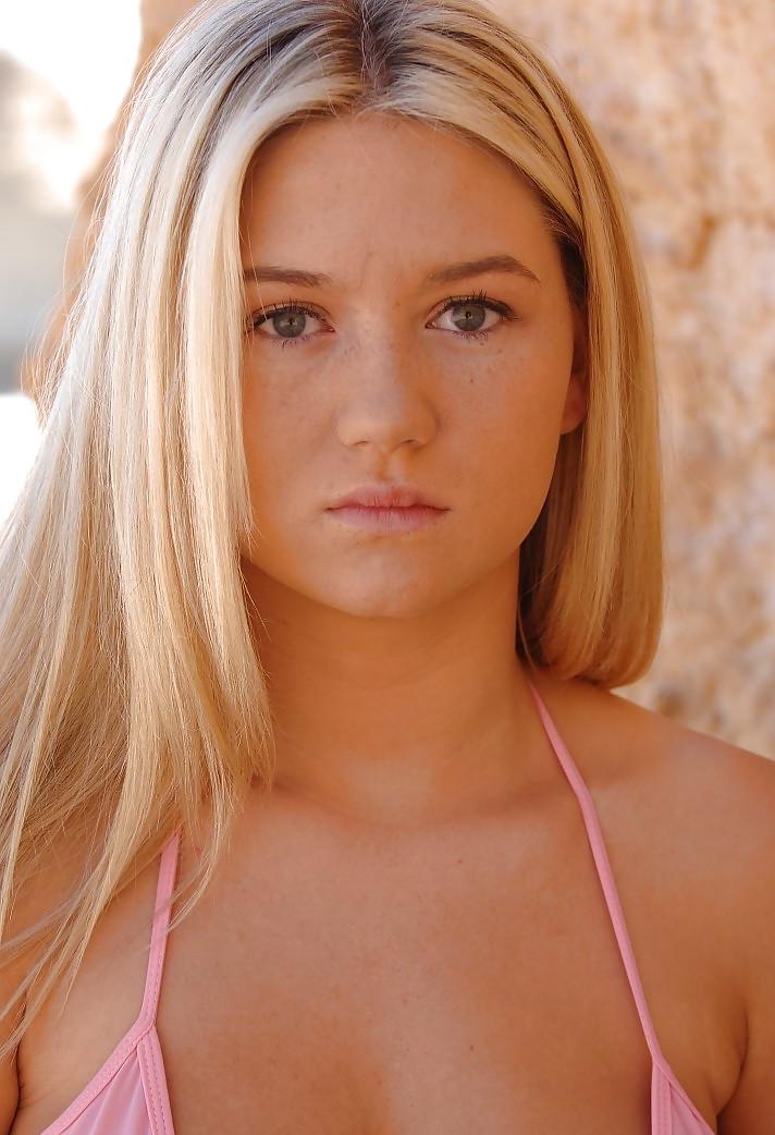 25P Hot busty blonde getting out of her bikini at the beach
