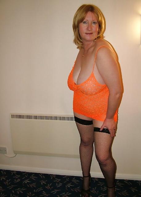 15P Mature blond woman poses