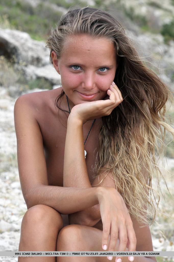 18P Solo girl Mango A modeling naked on rocky beach after disrobing