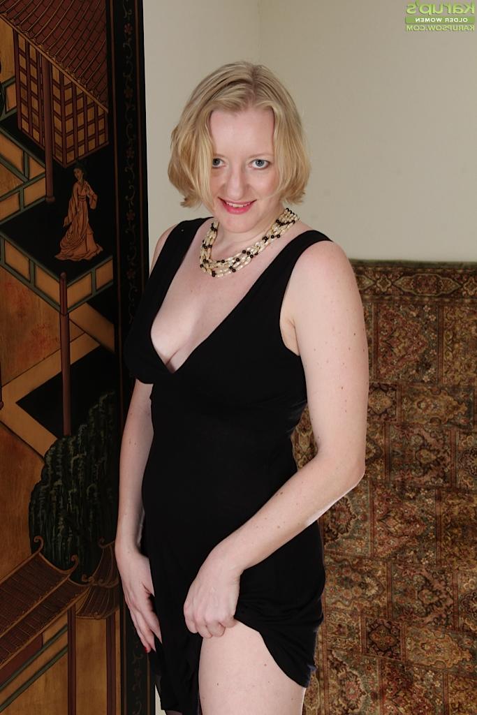 16P Older Euro woman Anya Volcov posing non nude in black stockings and dress
