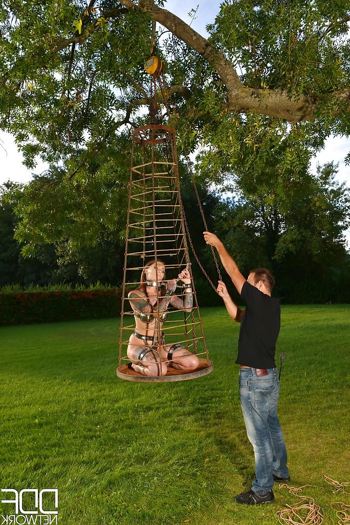 16P Inked fetish model undergoing outdoors slave training in collar