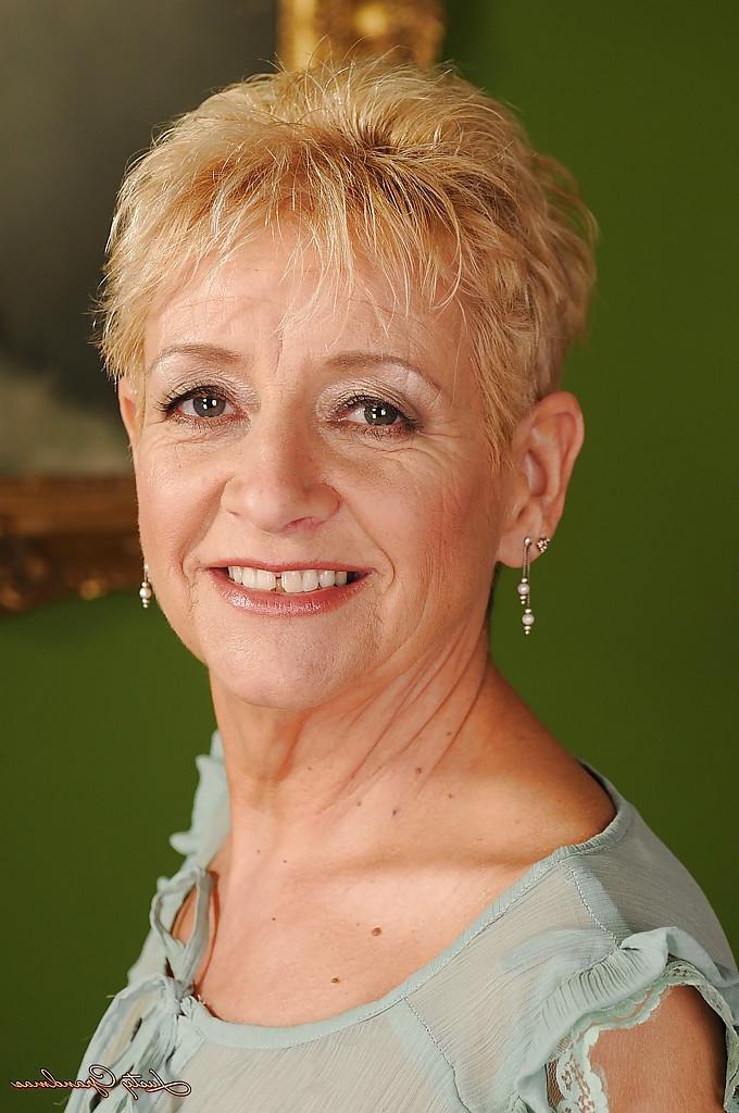 16P Smiley short-haired granny with ample ass gets rid of her clothes