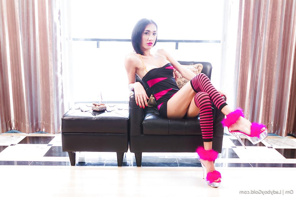 16P Naughty Asian shemale Om posing solo in knee high socks and high heels