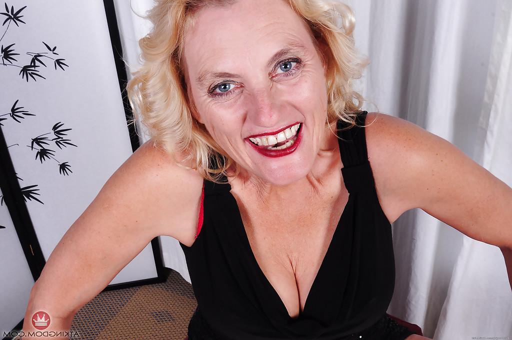 16P Mature blonde dame Lady Dalbin stripping naked to spread shaved granny twat