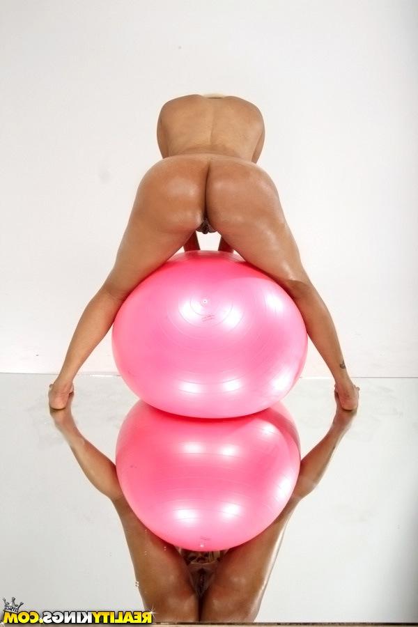 16P Oiled babe is masturbating her tight pussy while on a pink ball