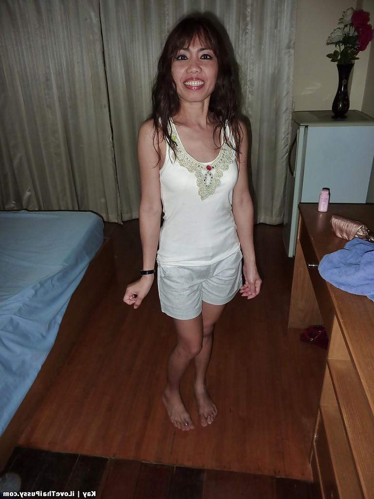 13P Naughty asian babe with slender legs stripping off her clothes