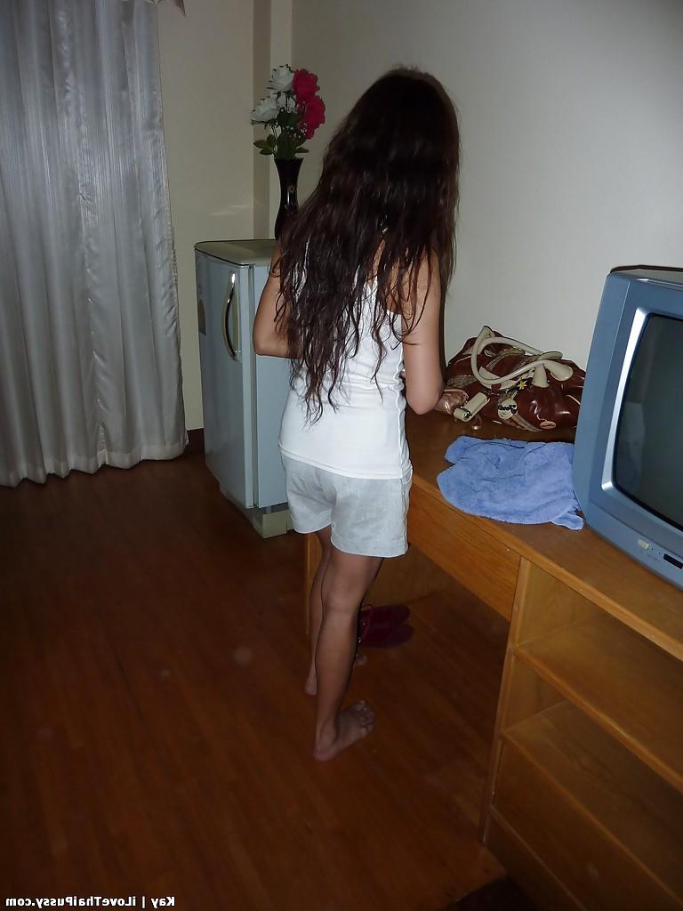 13P Naughty asian babe with slender legs stripping off her clothes
