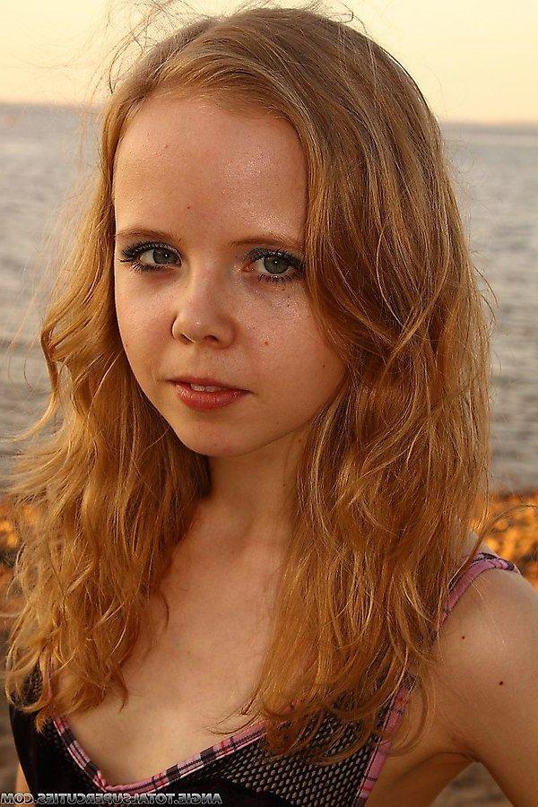 20P Pictures of Angie getting naked on a beach