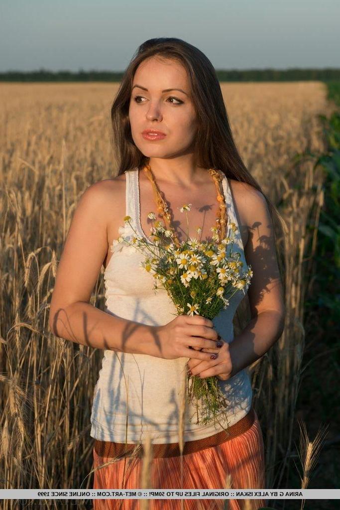 17P Pretty girl Arina G shows off her hairy pussy for you in a field