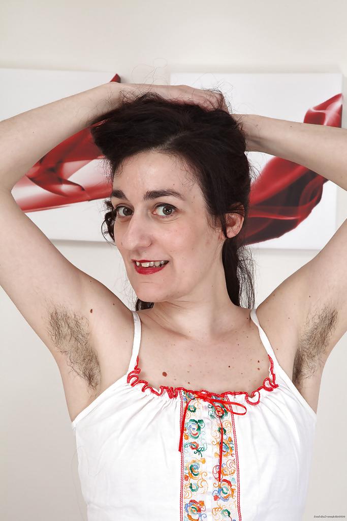16P Ugly mature woman with hairy armpits and pussy strips on camera.