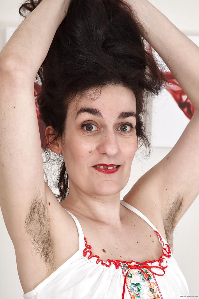 16P Ugly mature woman with hairy armpits and pussy strips on camera.
