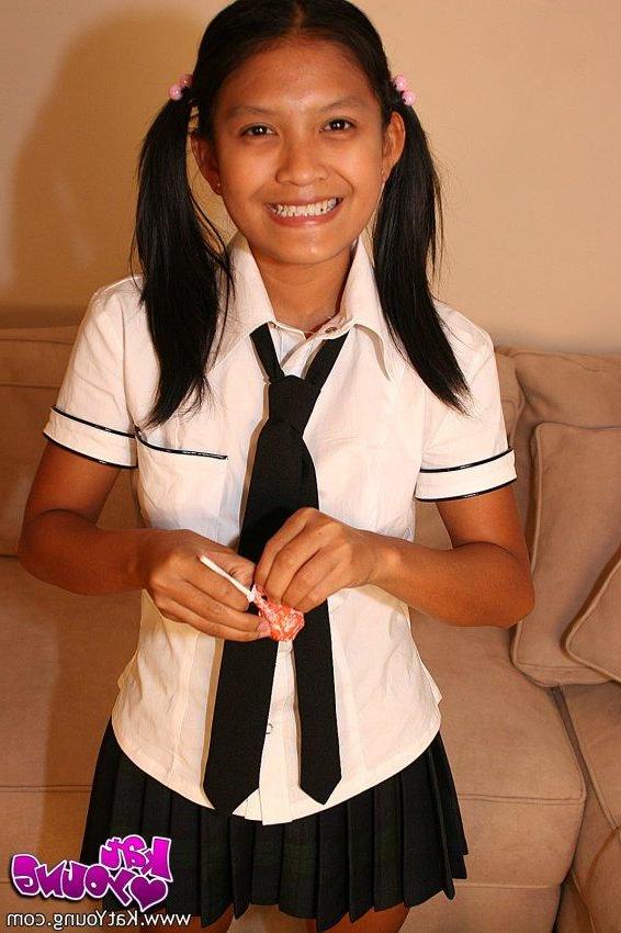 20P Kat Young strips wearing a school girl uniform