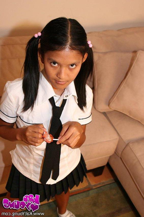 20P Kat Young strips wearing a school girl uniform