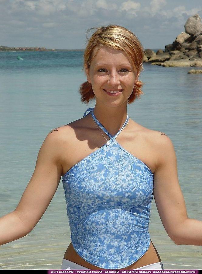 20P Pictures of teen Lindsey Marshal going for a skinny dip on a beach