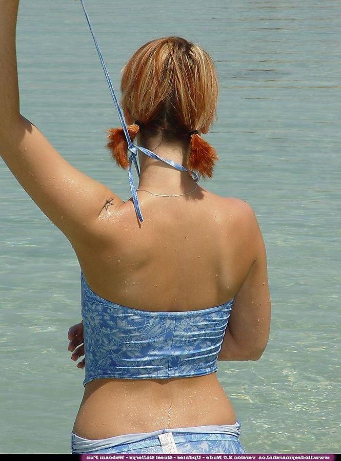 20P Pictures of teen Lindsey Marshal going for a skinny dip on a beach