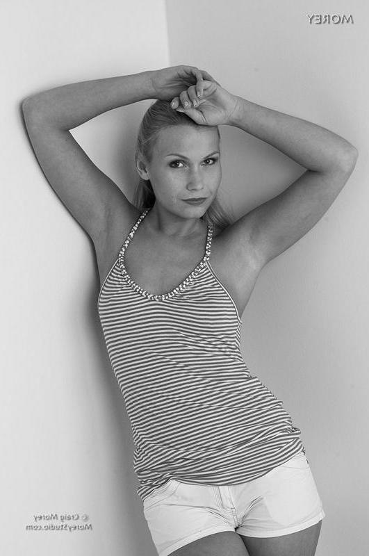 12P Blonde babe Mikelle strips in black and white