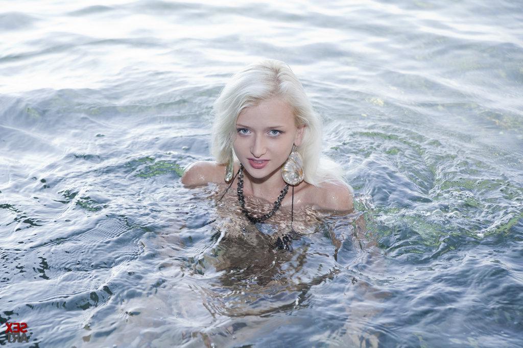 12P Always tempting, Nika's youthful exuberance and seductive demeanor is highly engaging as she strips her silver bikini and tease her fans with wide open poses at the rocky beach.