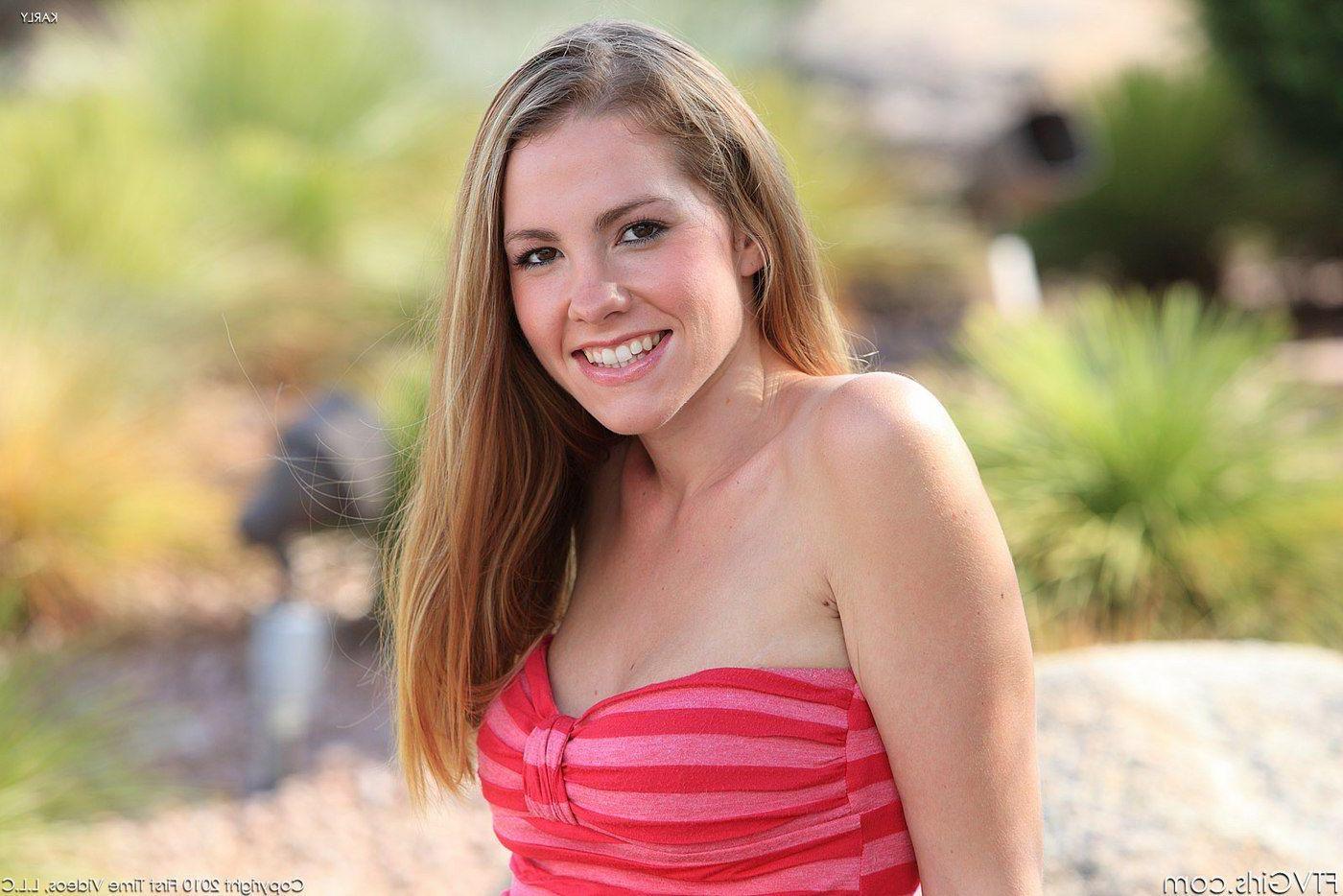 15P Pictures of redhead teen Karly flashing her tits and pussy outside