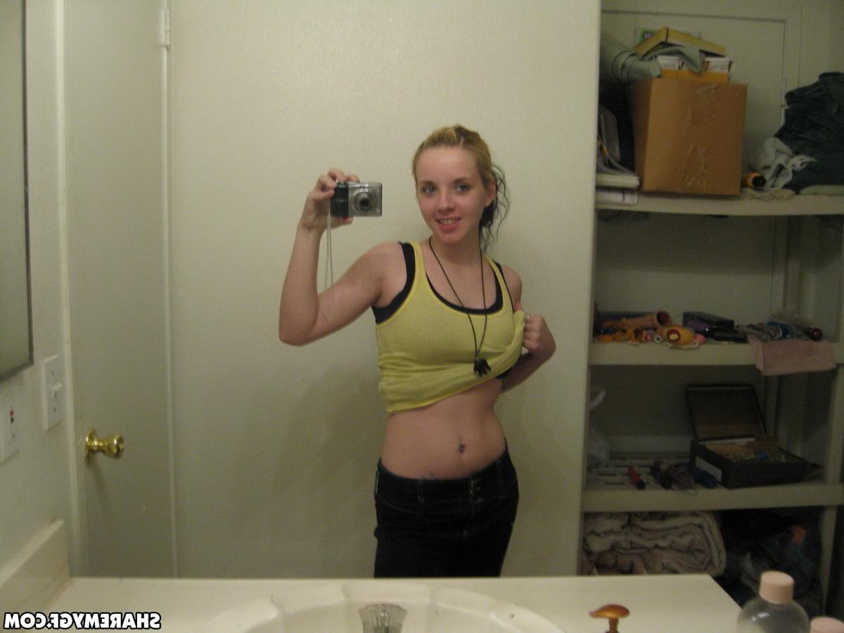 12P Cute blonde gets naked and takes selfshot mirror pictures of her pierced nipples