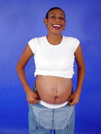 25P Pregnant black woman showing off