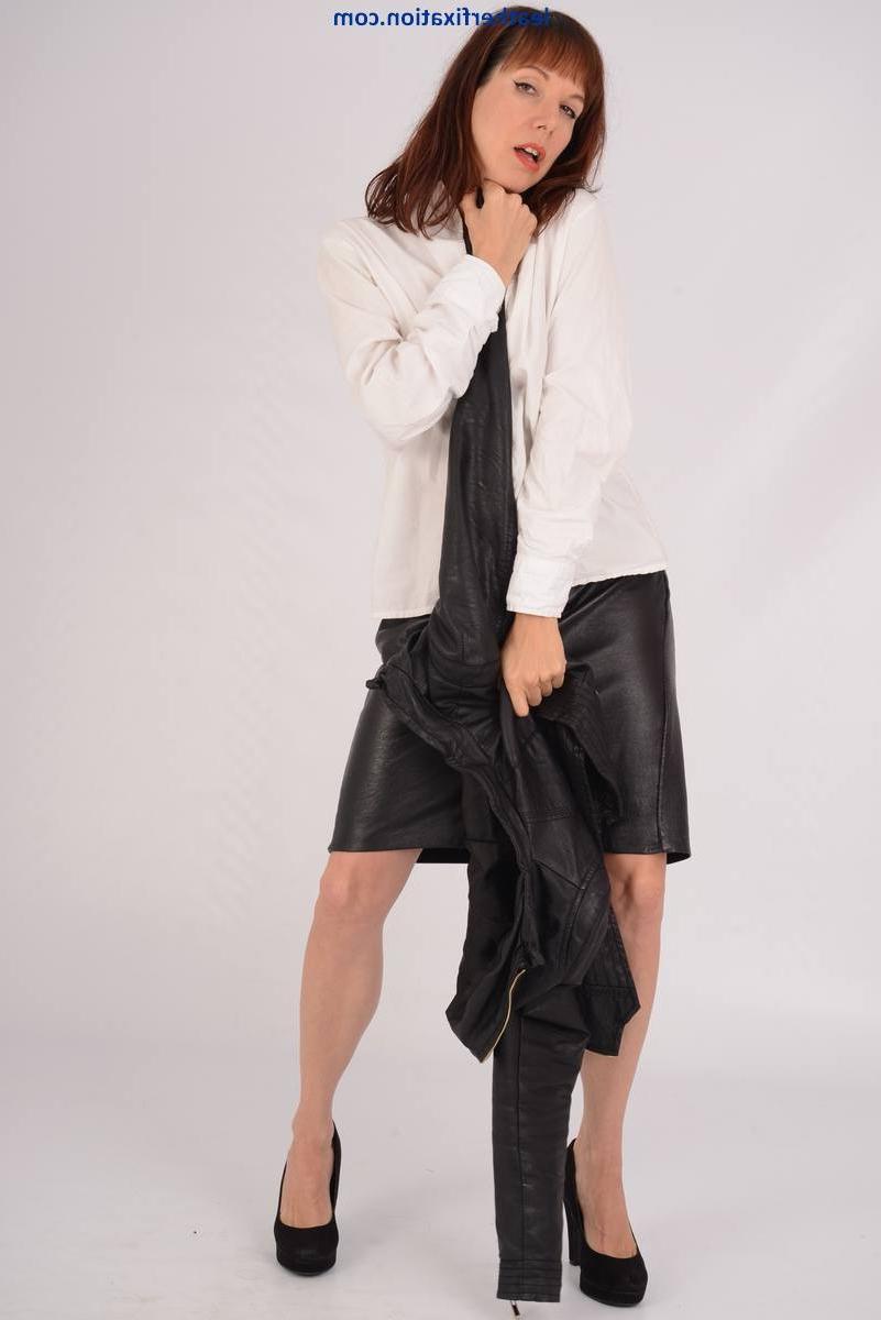 15P Businesswoman showing off at office in a leather skirt