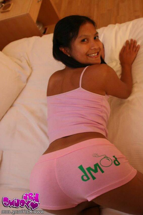 16P Kat Young poses in pink shorts on her bed