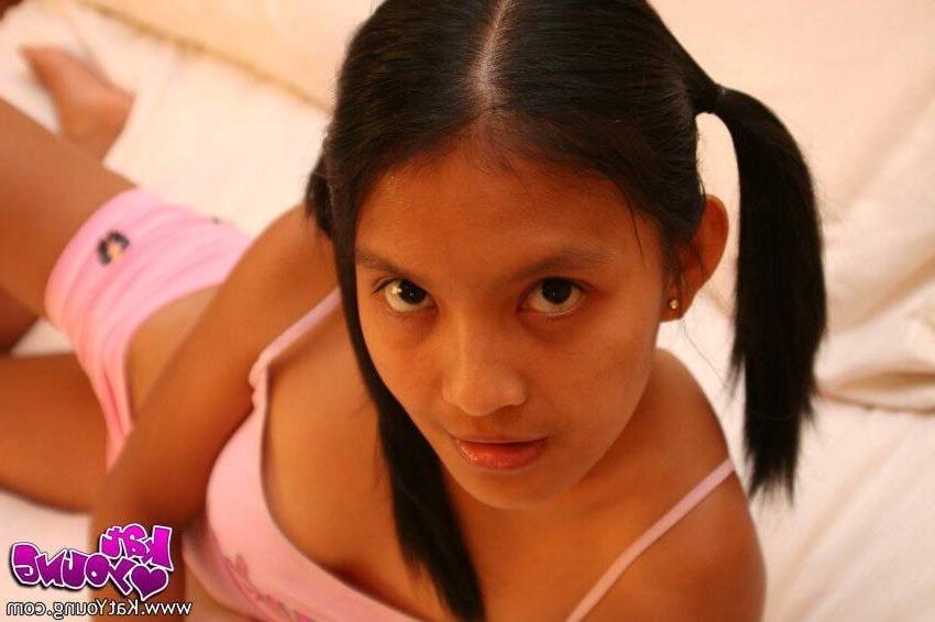 16P Kat Young poses in pink shorts on her bed