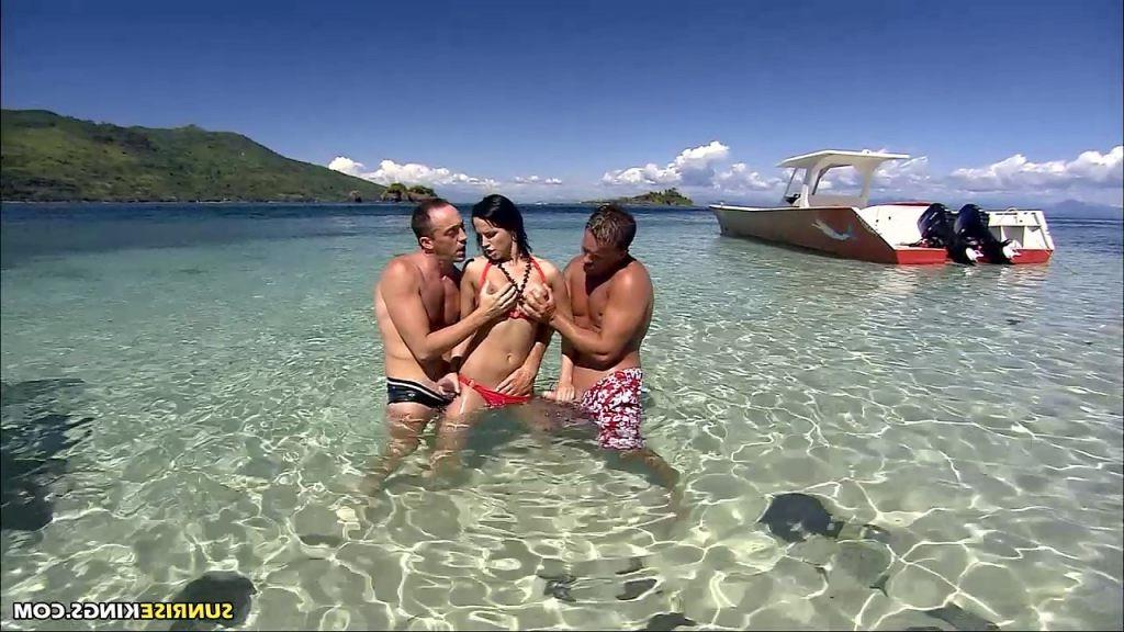 16P Busty brunette fucked by two cocks on the beach in red bikini
