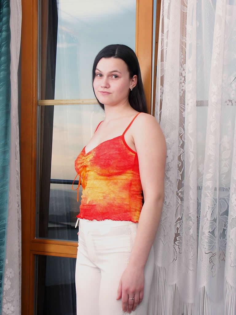 18P Horny amateur teen strips and poses in the window