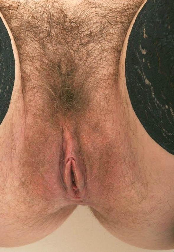 15P redhead in glasses spreading her hairy pussy