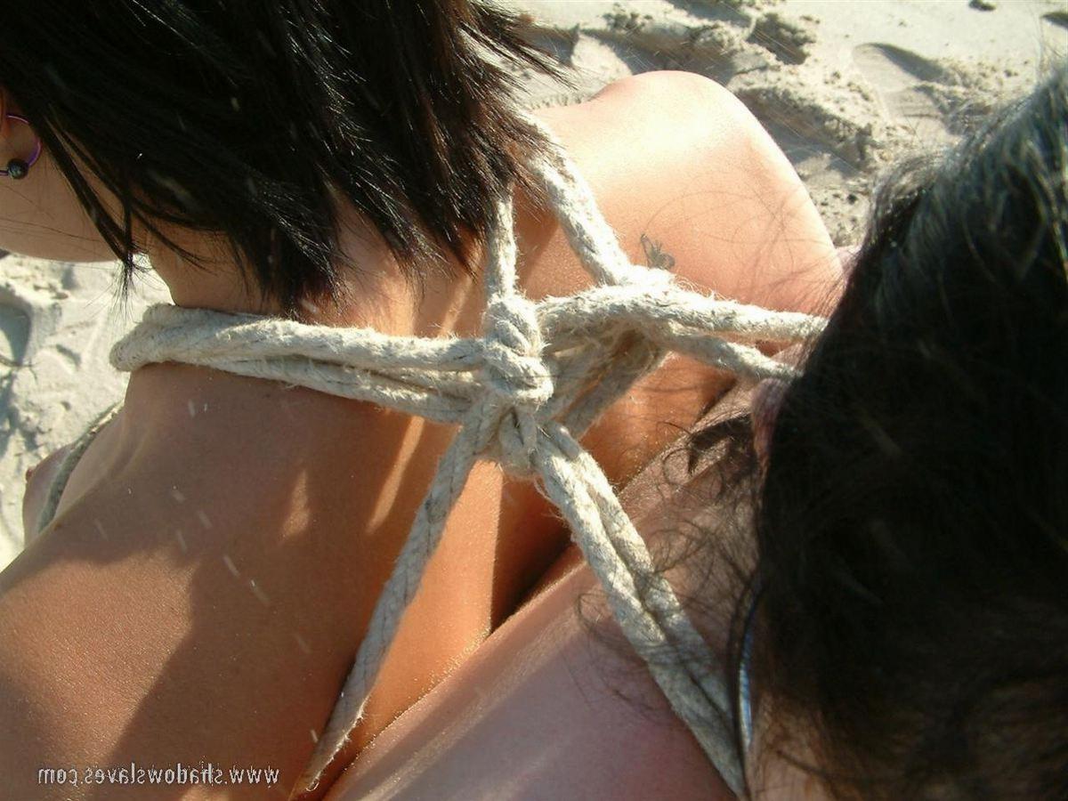 16P Two slavegirls tied together on the public bondage beach