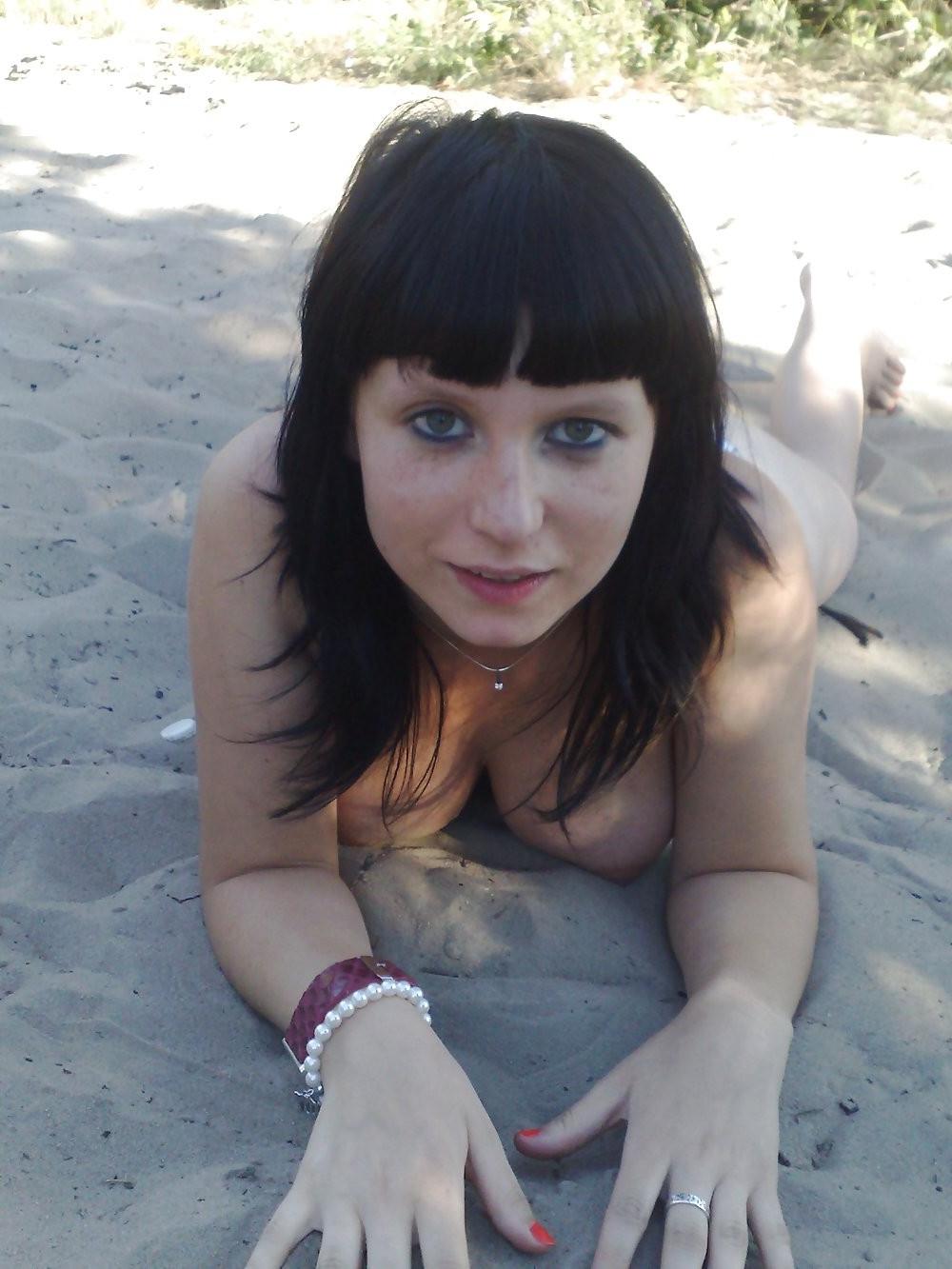 15P Sexy brunette nudist strips bare at a public beach