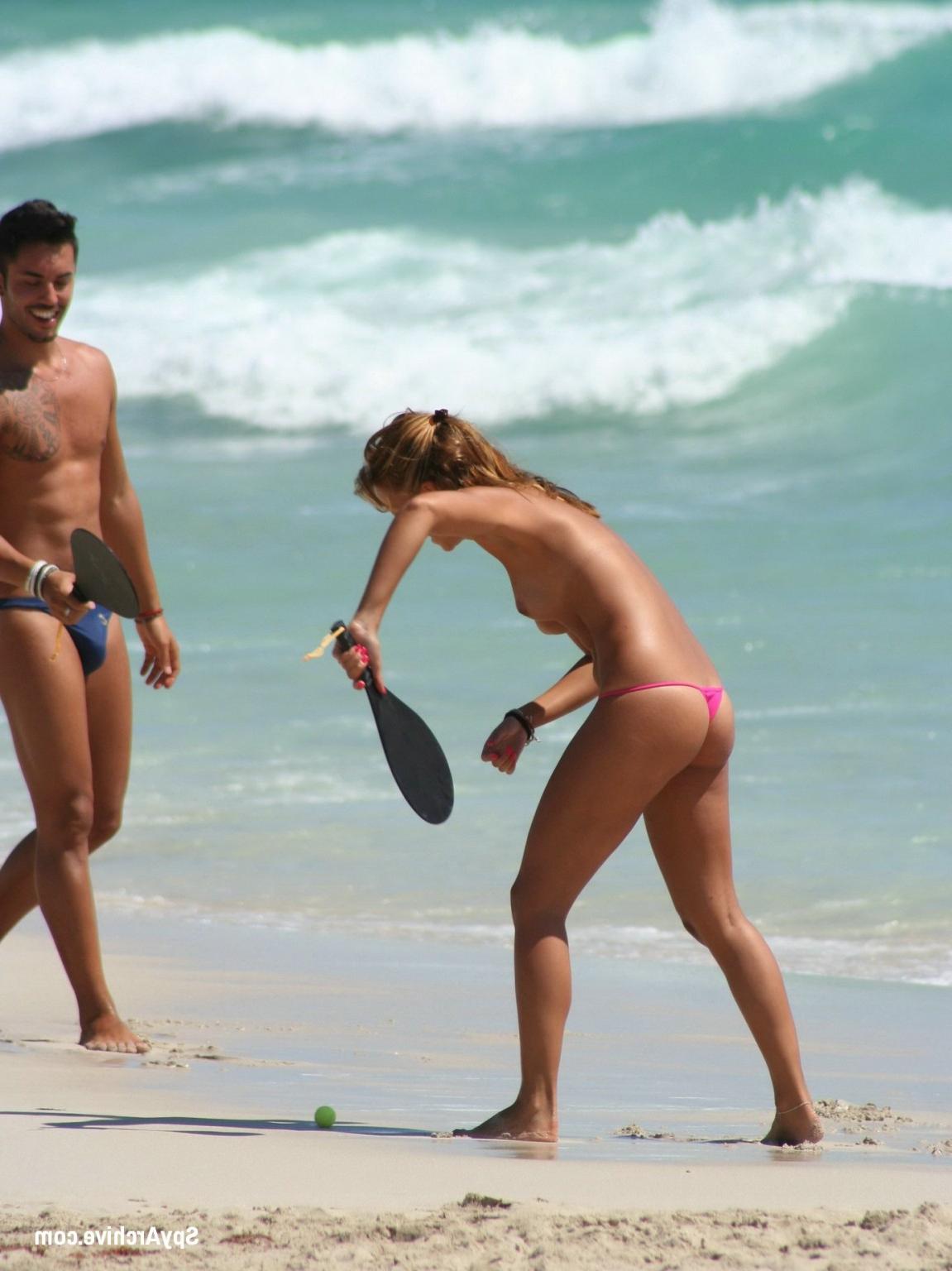 15P Voyeur shots of a cute topless girl playing at the beach